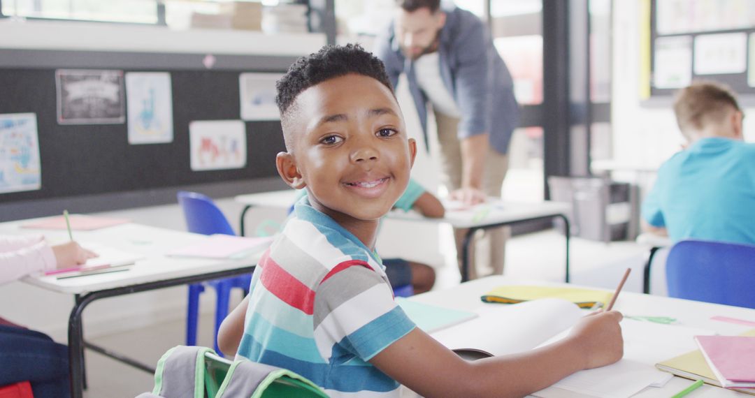 Smiling African American Boy in Classroom Participating in Lesson - Free Images, Stock Photos and Pictures on Pikwizard.com