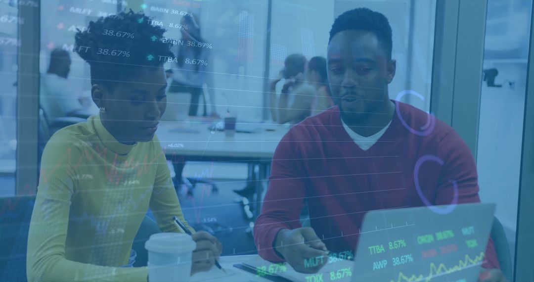 Diverse Business Team Analyzing Financial Data on Laptop