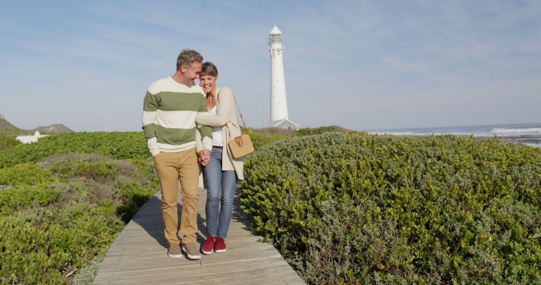 Happy Couple Enjoying Walk Near Scenic Lighthouse - Free Images, Stock Photos and Pictures on Pikwizard.com