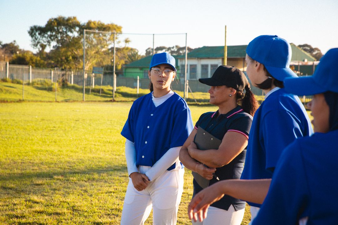 Female Baseball Team Discussing Game Tactics with Coach - Free Images, Stock Photos and Pictures on Pikwizard.com