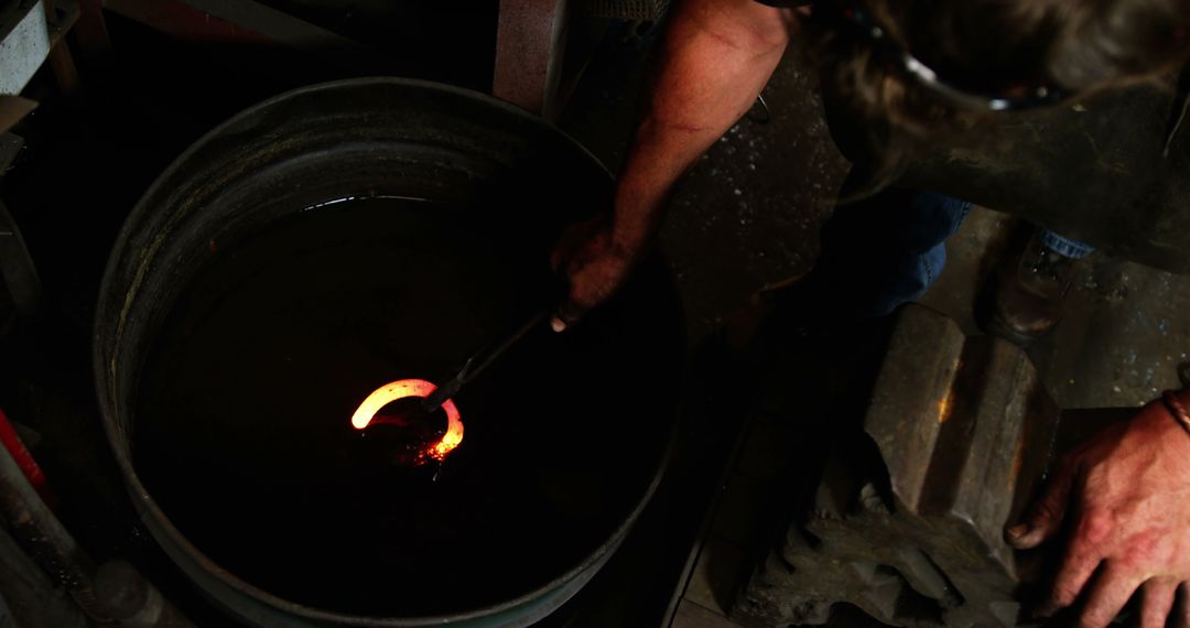 Blacksmith Quenching Glowing Hot Metal in Oil - Free Images, Stock Photos and Pictures on Pikwizard.com