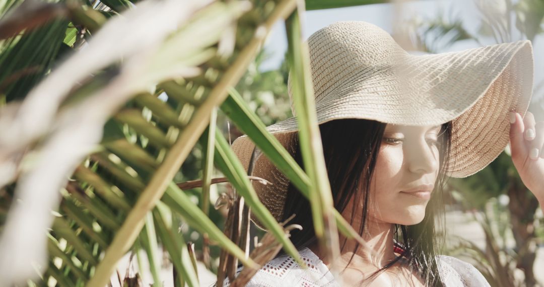 Woman in Sun Hat Relaxing in Tropical Garden - Free Images, Stock Photos and Pictures on Pikwizard.com