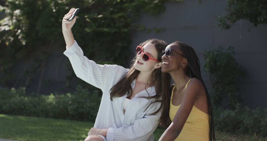 Two Friends Taking Selfie Outdoors in Sunlight - Free Images, Stock Photos and Pictures on Pikwizard.com