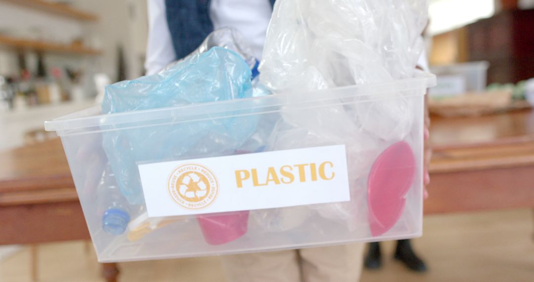 Person Holding Plastic Recyclables Container for Environmental Awareness - Free Images, Stock Photos and Pictures on Pikwizard.com