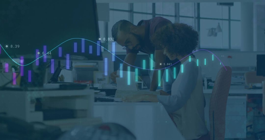 Coworkers Analyzing Data with Graphs in Modern Office Setting