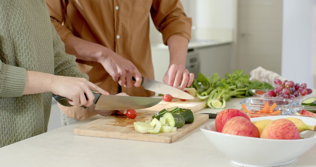 Couple Slicing Vegetables Together in Modern Kitchen