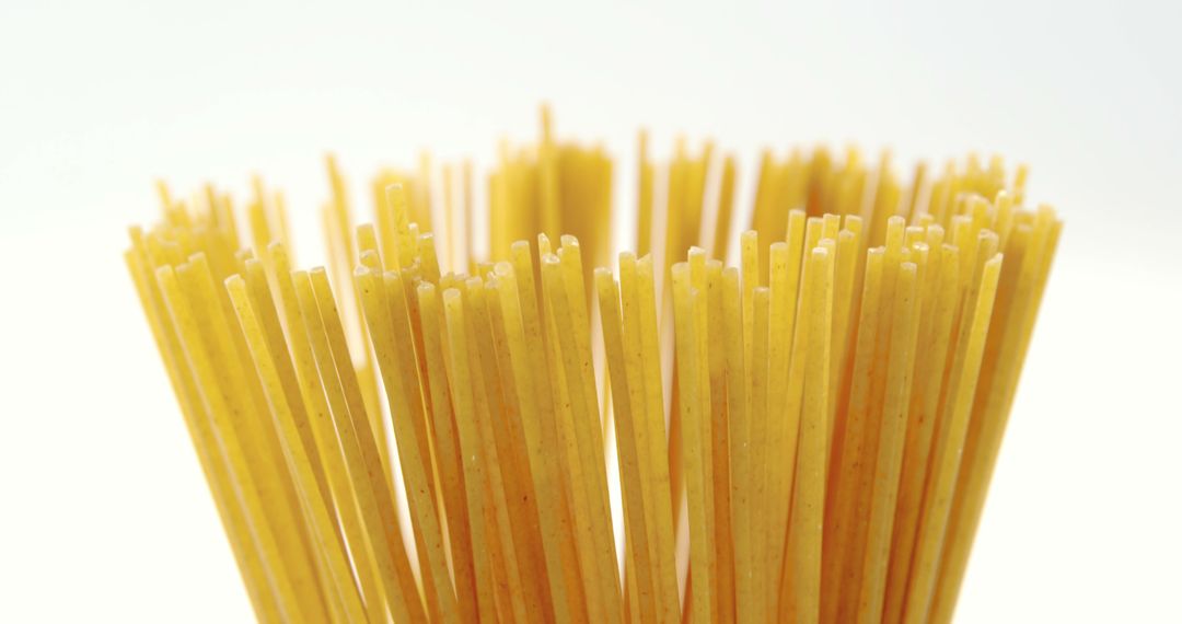 Close-Up of Uncooked Italian Pasta Sticks on White Background - Free Images, Stock Photos and Pictures on Pikwizard.com