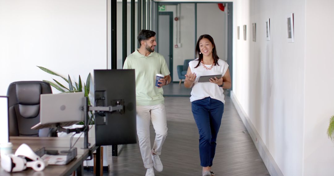 Colleagues Smiling and Chatting in Modern Office Corridor