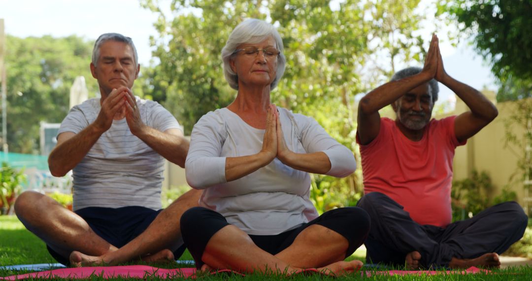 Seniors Practicing Yoga Meditation Outdoors in Tranquil Garden - Free Images, Stock Photos and Pictures on Pikwizard.com