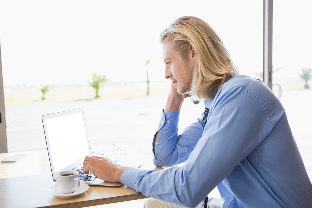Young Professional Using Transparent Laptop in Cafe Breeze