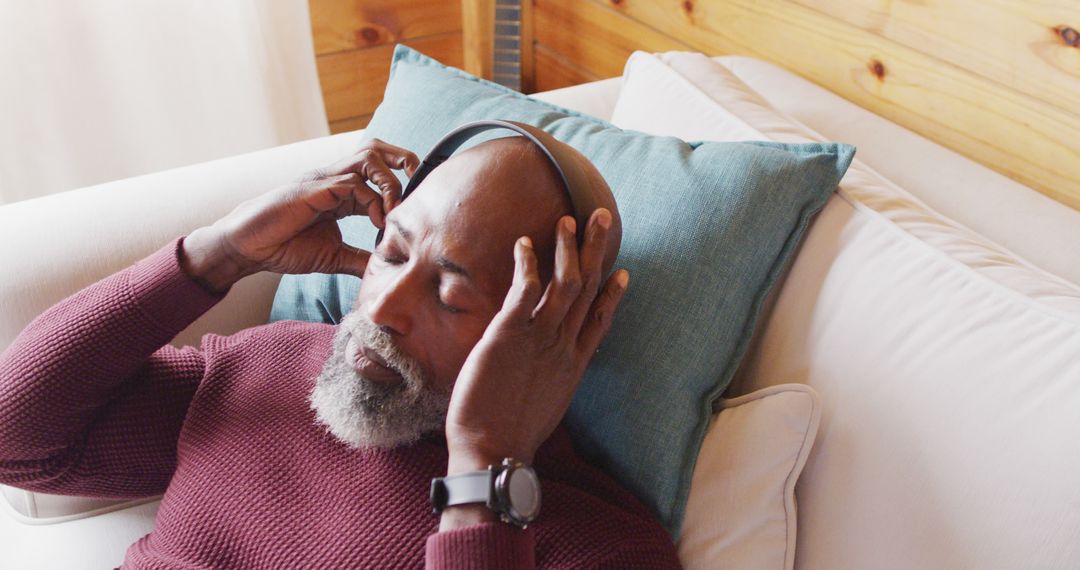 Senior Man Relaxing on Couch and Listening to Music with Headphones - Free Images, Stock Photos and Pictures on Pikwizard.com