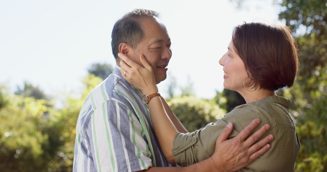 Affectionate Couple Embraced in Tranquil Sunlit Garden