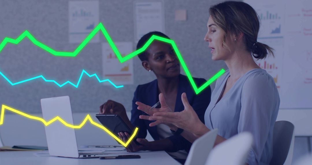 Women Discussing Analytics with Graph Overlays in Meeting Room