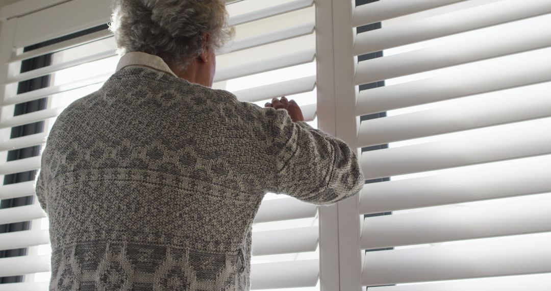 Senior Man Peeking Through Blinds in Cozy Home - Free Images, Stock Photos and Pictures on Pikwizard.com