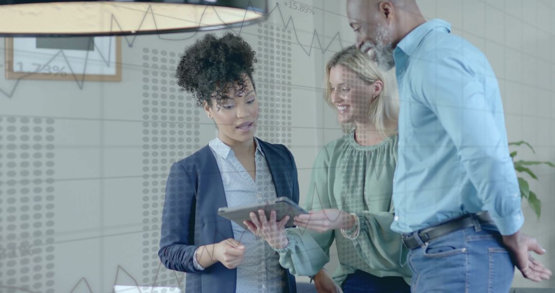 Diverse Business Team Analyzing Financial Data on Tablet