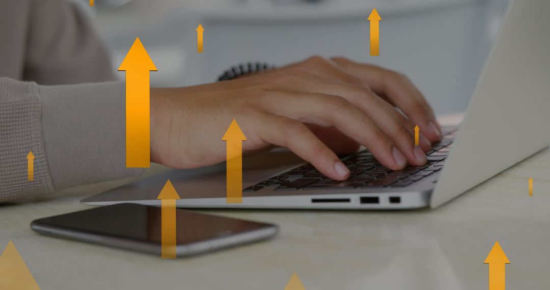 Hands Typing with Golden Arrows Depicting Growth and Success Concept