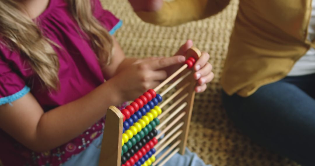 Child Learning to Use Wooden Abacus with Adult Guidance - Free Images, Stock Photos and Pictures on Pikwizard.com