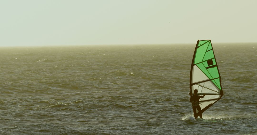 Windsurfer on Calm Sea at Sunset - Free Images, Stock Photos and Pictures on Pikwizard.com