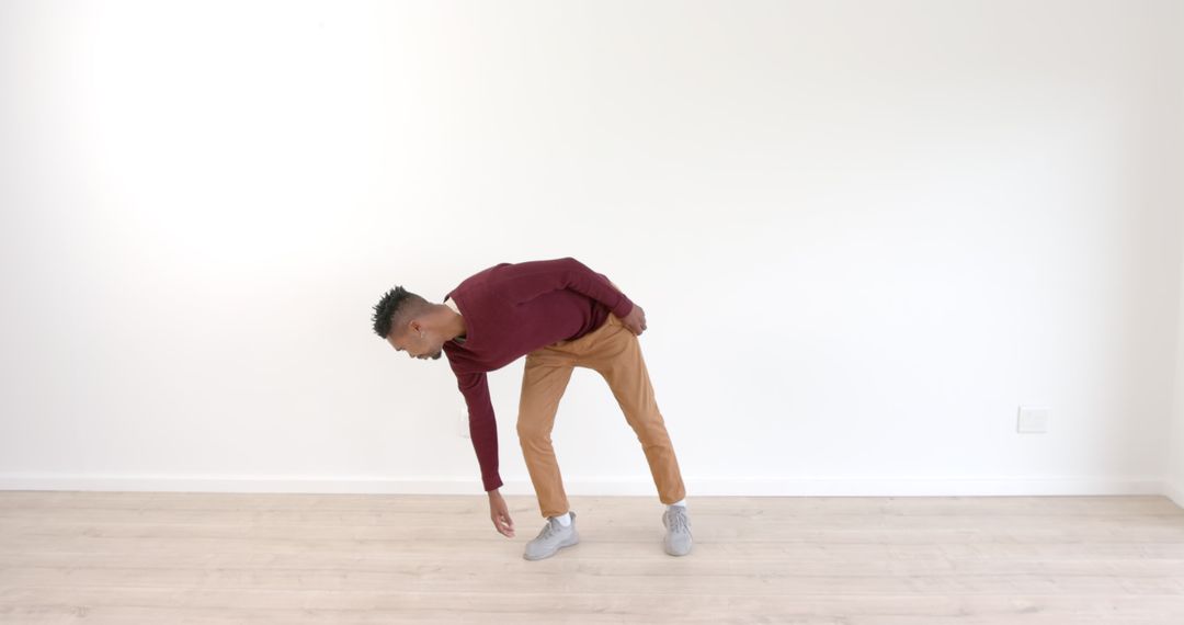 Man Dancing Energetically in Bright Minimalist Room