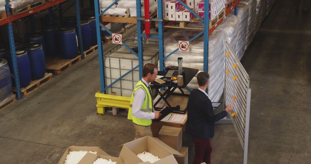 Warehouse Managers Analyzing Workflow in Storage Facility