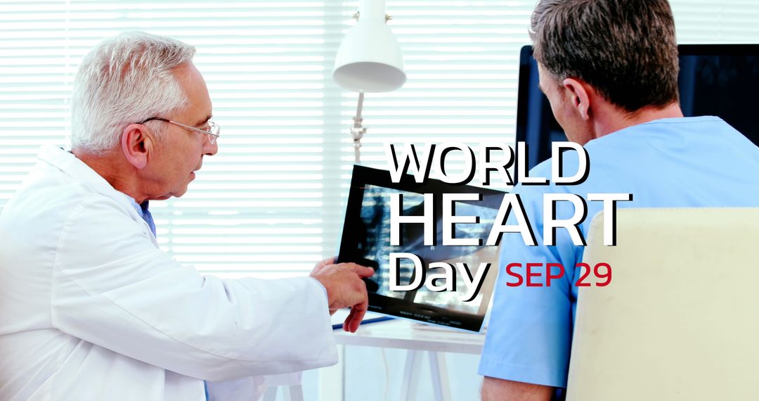 Doctors Discussing Heart Health Using Laptop Technology on World Heart Day