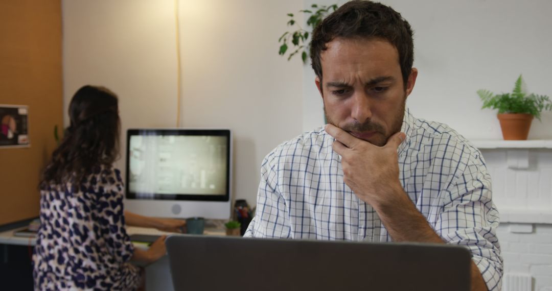 Concerned Employee Concentrating on Laptop Work in Office - Free Images, Stock Photos and Pictures on Pikwizard.com