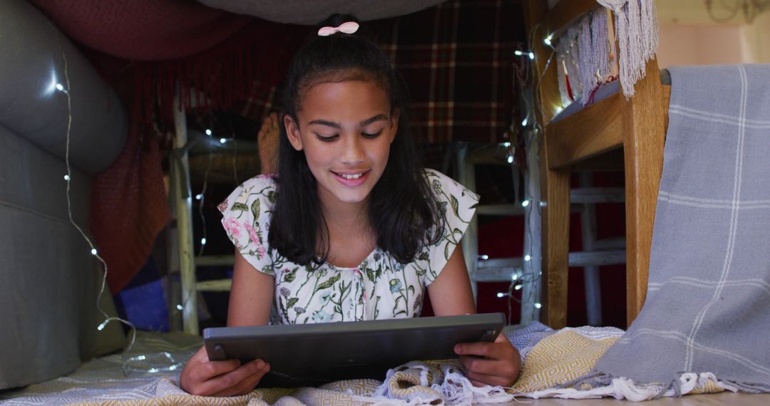 Smiling Girl Using Tablet in a Blanket Fort - Free Images, Stock Photos and Pictures on Pikwizard.com