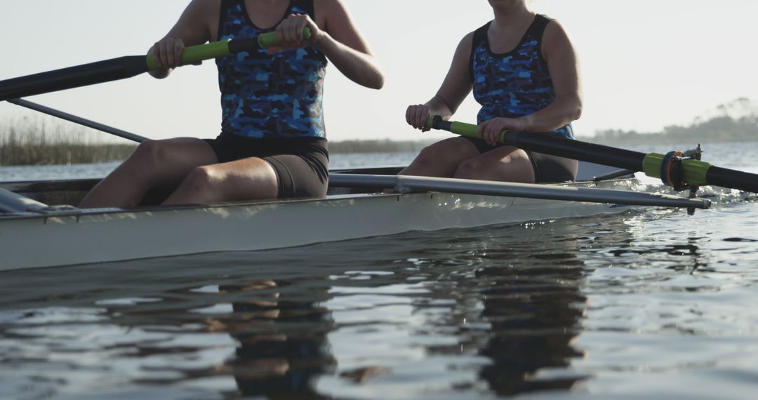 Couple Rowing on Serene Lake Exhibiting Teamwork and Unity