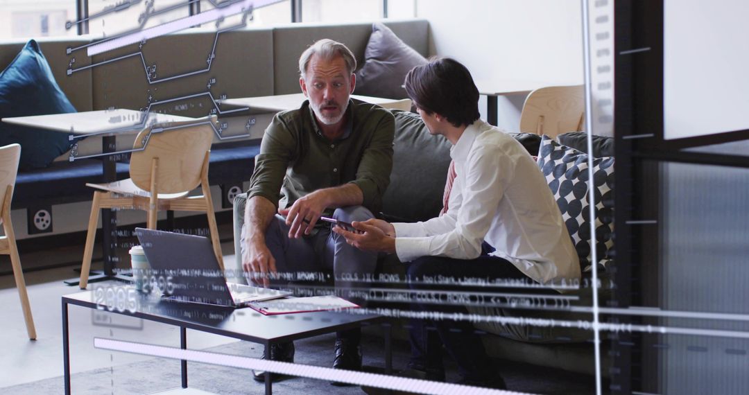 Coworkers Collaborating in Office Lounge Discussion