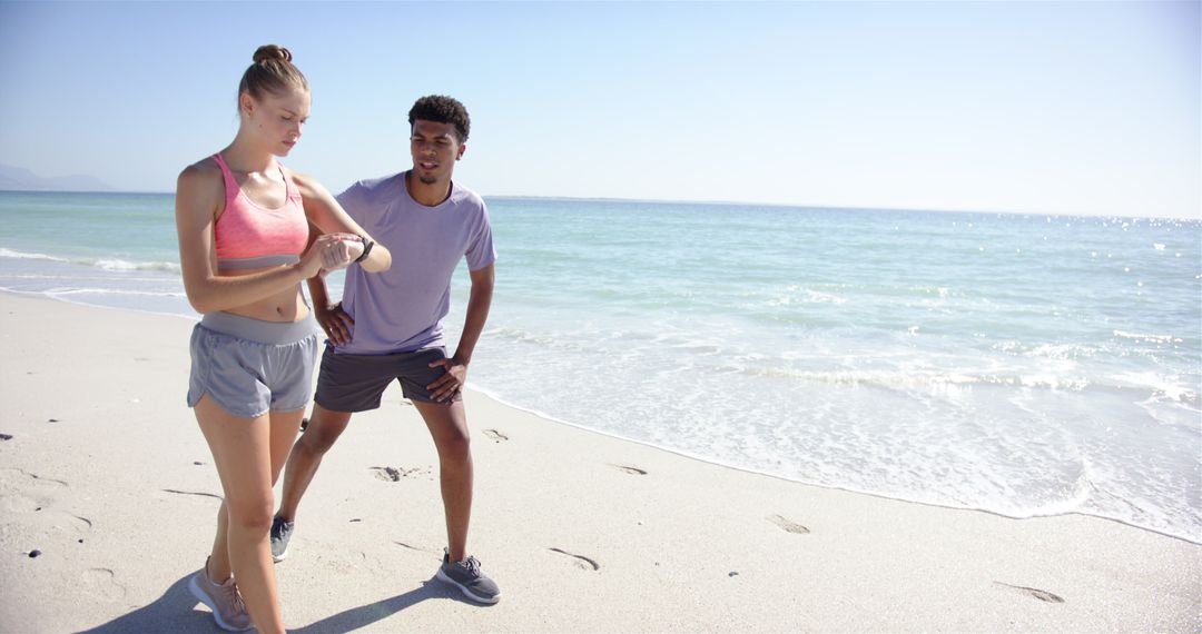 Active Beach Workout with Young Couple Taking a Break
