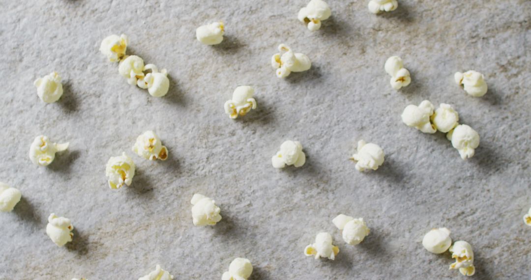 Close-Up Popcorn Scattered on Gray Stone Surface