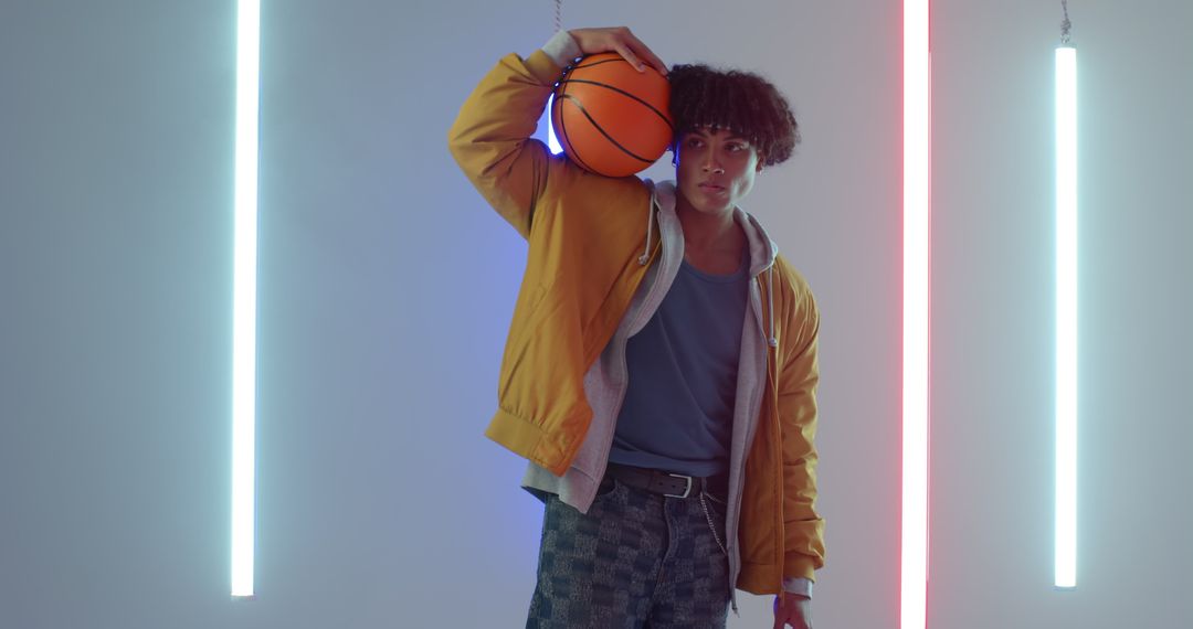 Young African American Man with Basketball in Neon Lit Studio