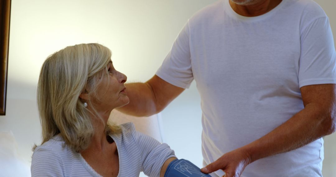 Senior Woman Receiving Blood Pressure Measurement from Elderly Man - Free Images, Stock Photos and Pictures on Pikwizard.com