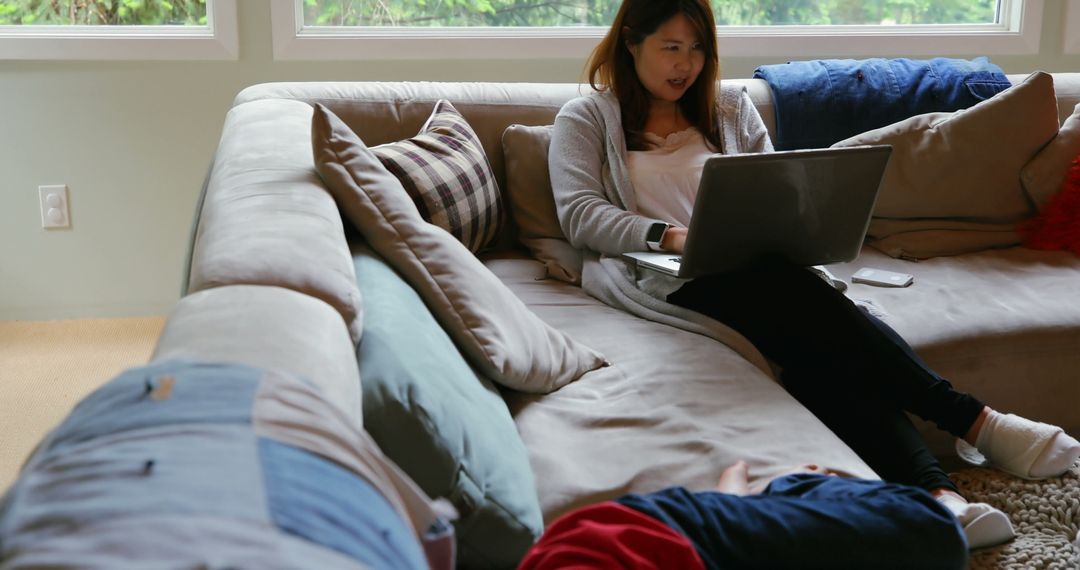 Mother and Son Using Laptop in Comfortable Living Room Setting