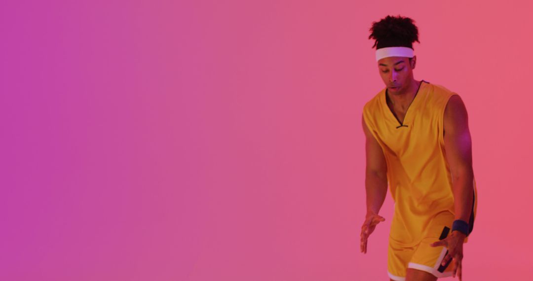 Image of biracial male basketball player throwing ball on orange to pink background - Free Images, Stock Photos and Pictures on Pikwizard.com