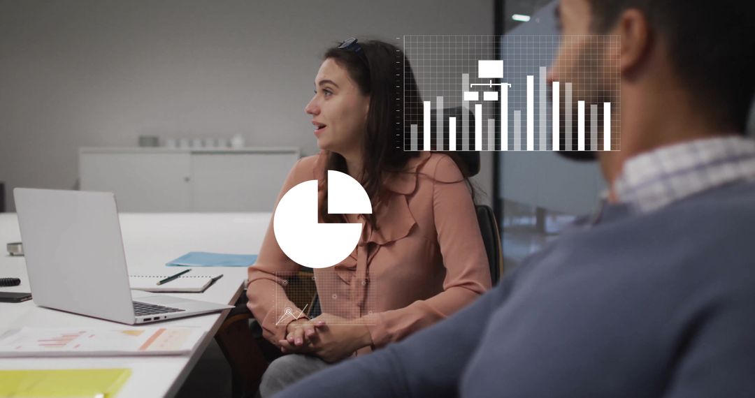 Colleagues Discussing Work with Digital Graphs Overlay