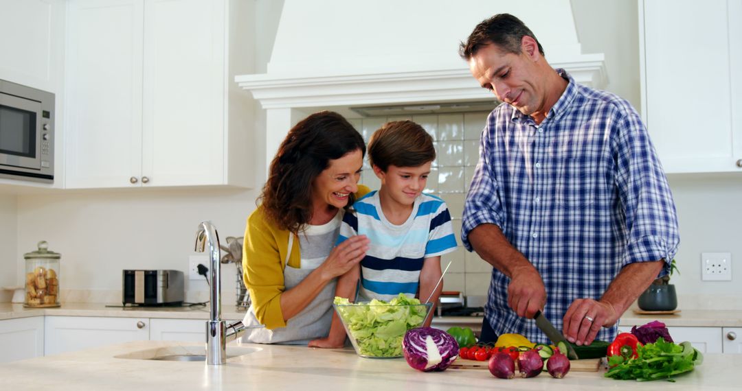 Happy Family Preparing a Healthy Salad Together in Kitchen - Free Images, Stock Photos and Pictures on Pikwizard.com