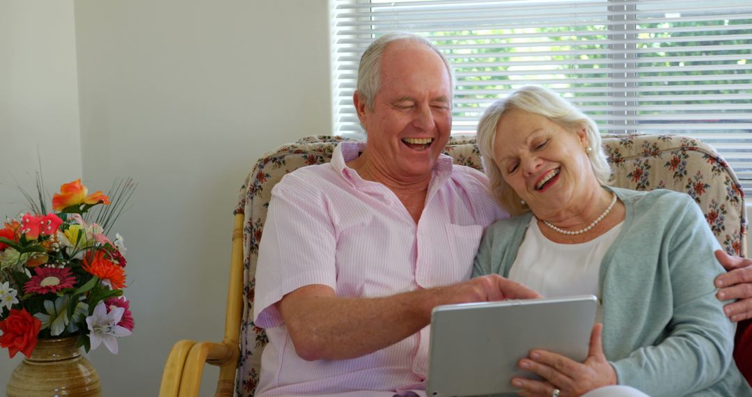 Senior Couple Enjoying Digital Tablet in Cosy Home Environment