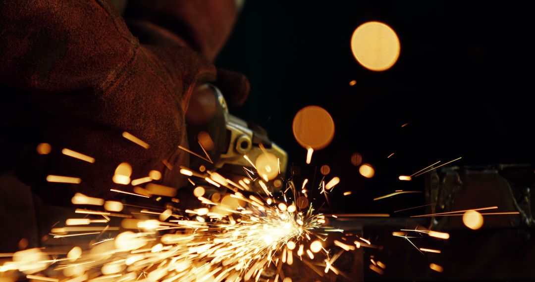 Welder Working with a Grinder Producing Sparks in Workshop - Free Images, Stock Photos and Pictures on Pikwizard.com