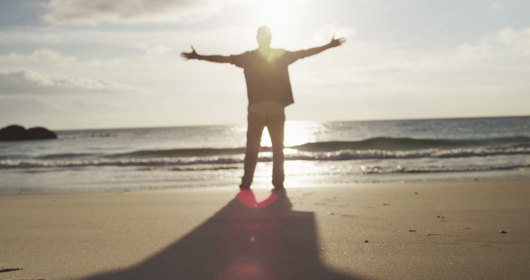 Man Enjoying Sunset on Beach with Open Arms - Free Images, Stock Photos and Pictures on Pikwizard.com