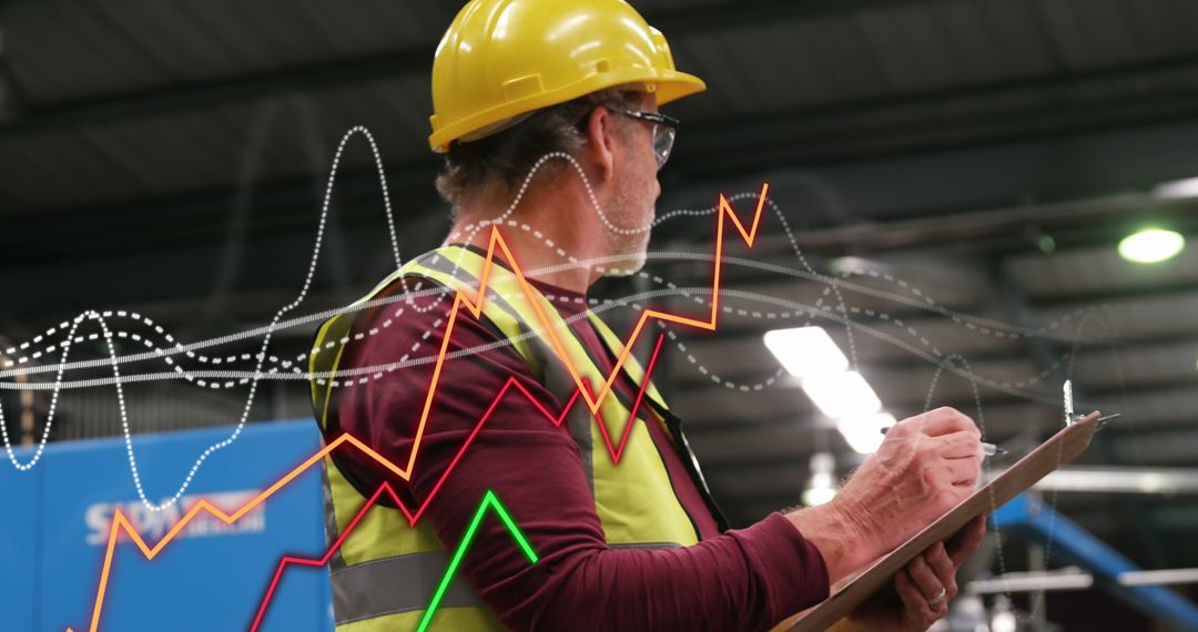 Construction Worker Analyzing Data Charts in Industrial Facility - Free Images, Stock Photos and Pictures on Pikwizard.com