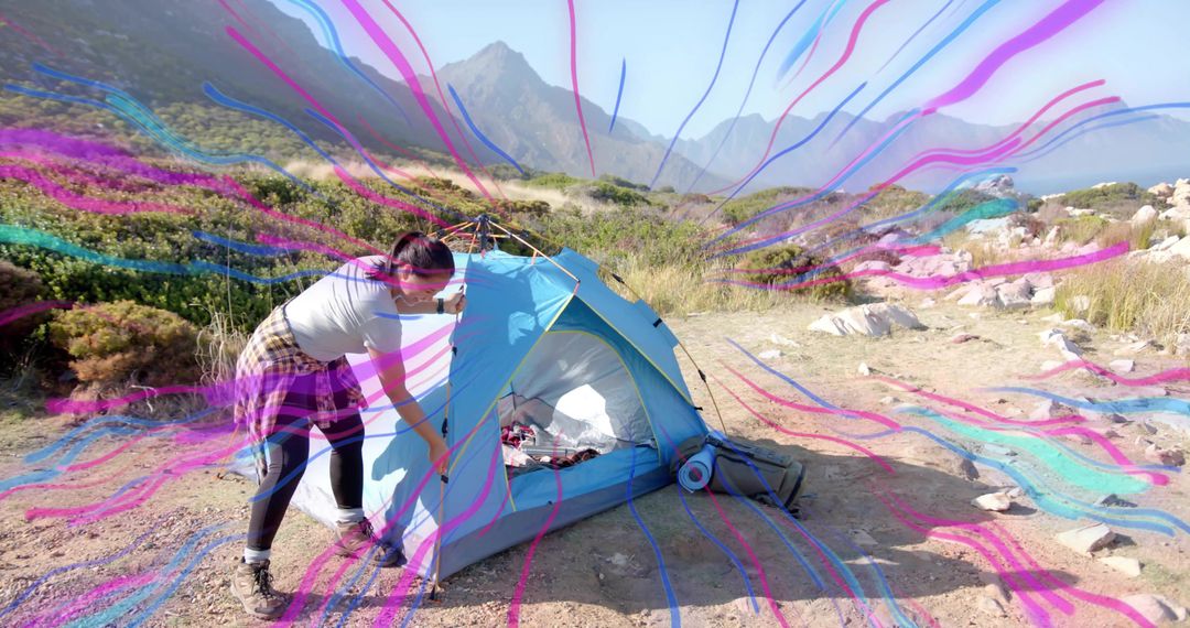 Adventurous Backpacker Setting Up Tent in Coastal Wilderness