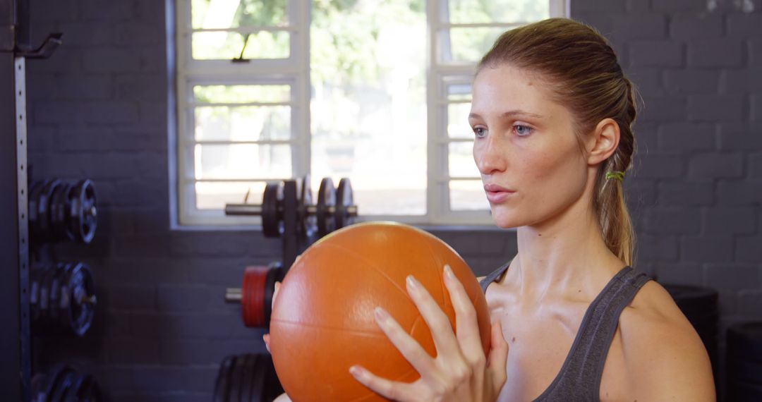 Woman Holding Medicine Ball at Gym Ready for Workout - Free Images, Stock Photos and Pictures on Pikwizard.com