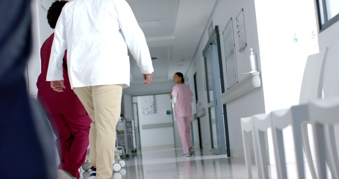 Medical Staff Walking Through Hospital Corridor - Free Images, Stock Photos and Pictures on Pikwizard.com