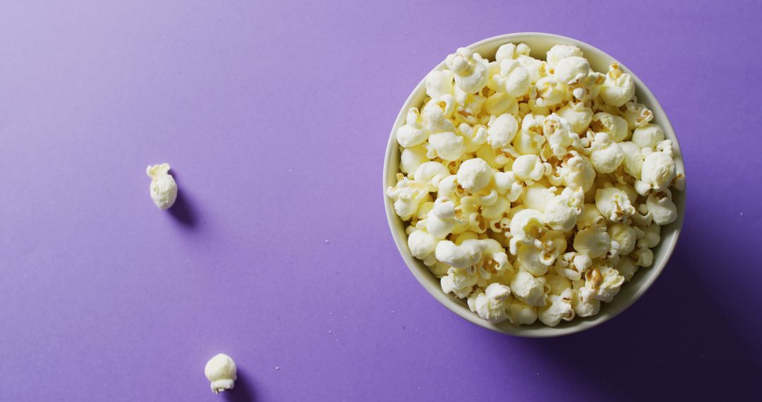 Bowl of Popcorn on Vibrant Purple Background with Copy Space - Free Images, Stock Photos and Pictures on Pikwizard.com