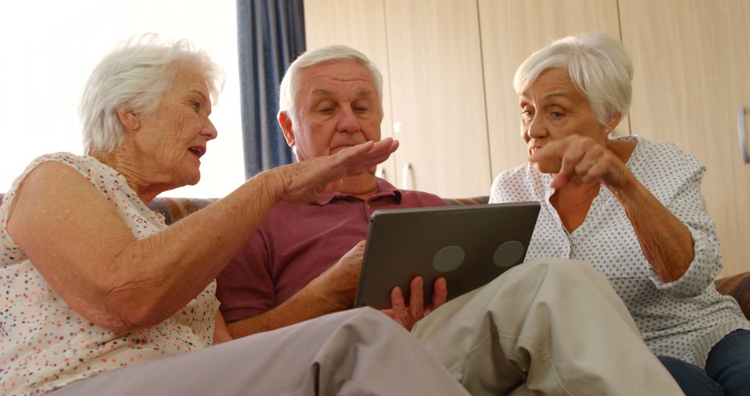 Senior Friends Using Tablet Together at Home - Free Images, Stock Photos and Pictures on Pikwizard.com