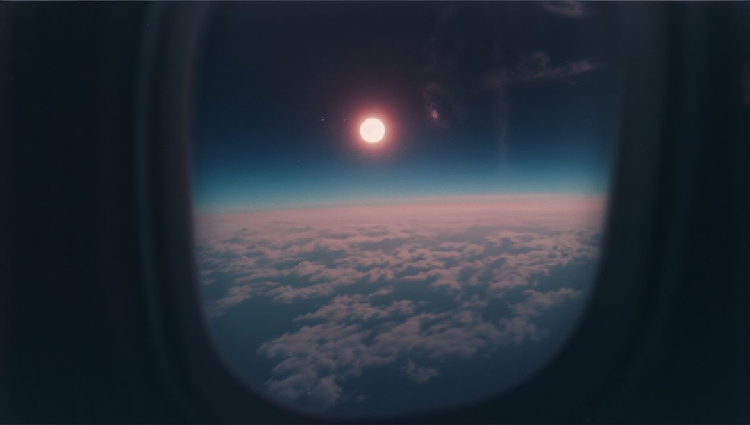 Aerial View Sun Above Clouds from Airplane Window