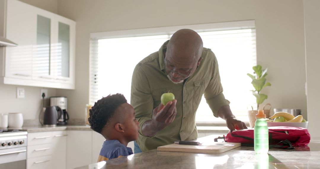 Grandfather Teaching Grandson Healthy Eating Habits in Modern Kitchen - Free Images, Stock Photos and Pictures on Pikwizard.com