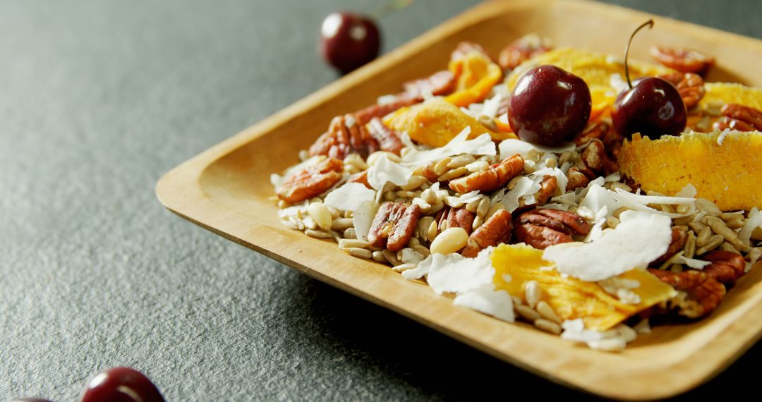 Fresh Granola with Nuts, Berries, and Dried Mango on Wooden Plate - Free Images, Stock Photos and Pictures on Pikwizard.com