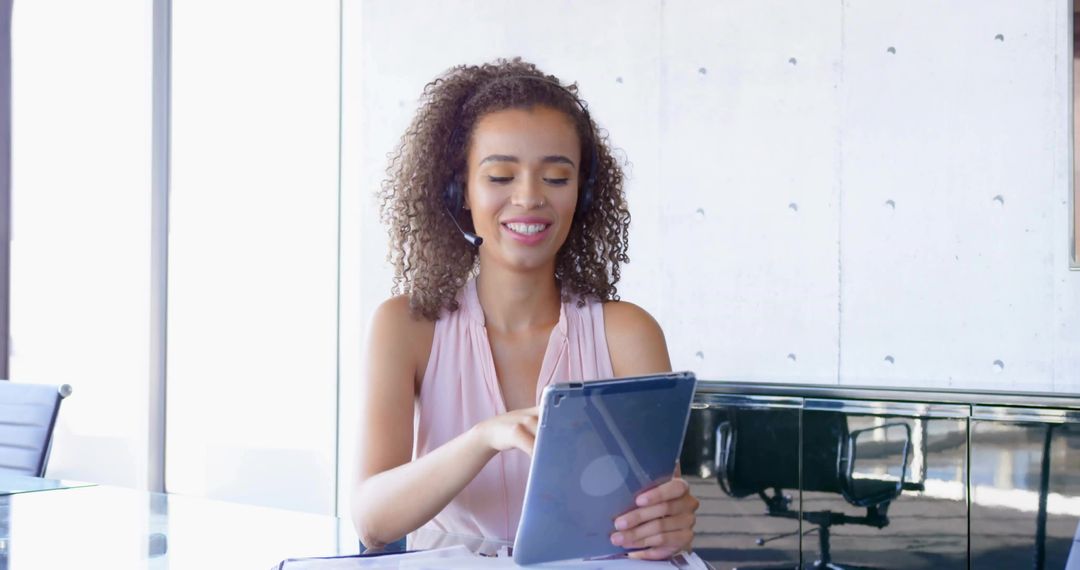 Smiling Professional Using Tablet in Modern Office Environment